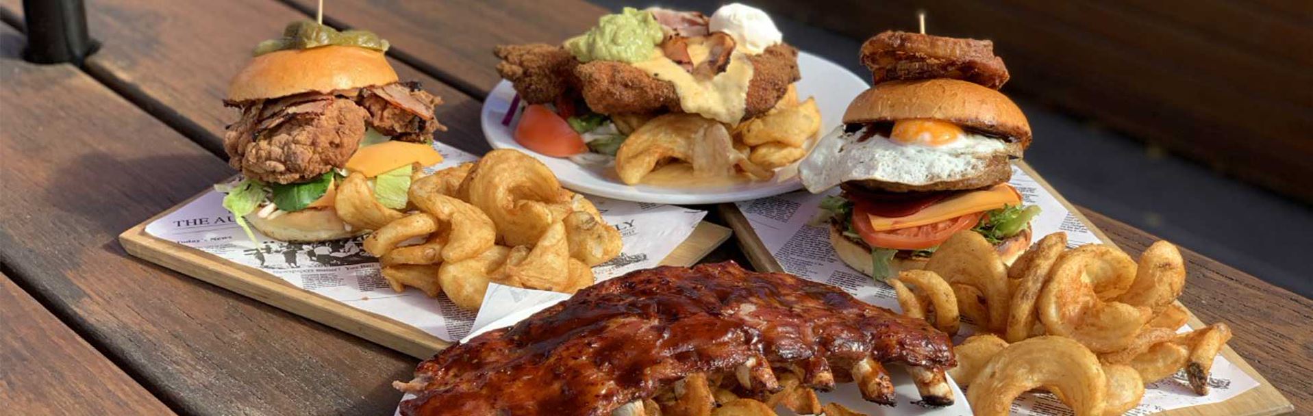 Various pub dishes on wooden table 